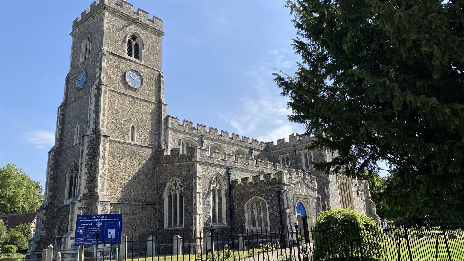 The full exterior of St Mary's, Ware, with its welcome sign
