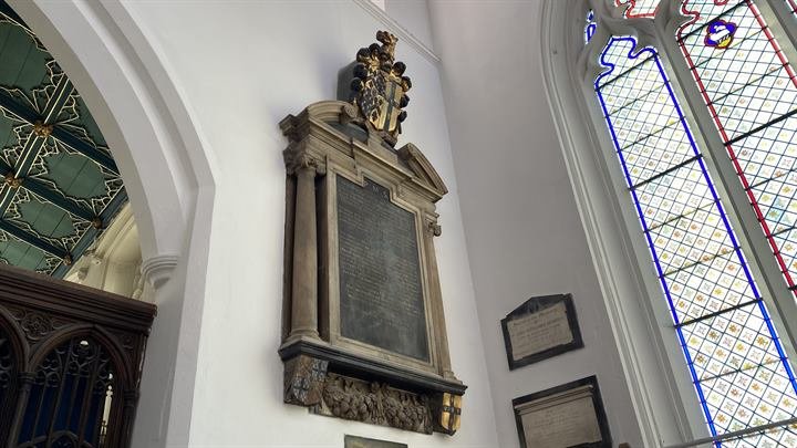 A carved wall monument with heraldry